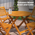 Wooden outdoor furniture set with a bottle of wood finish product on a patio.
